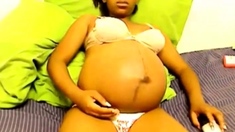 Heavily pregnant black cam chick