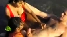 2 Indian girls with white guy in beach have fun blowjob..